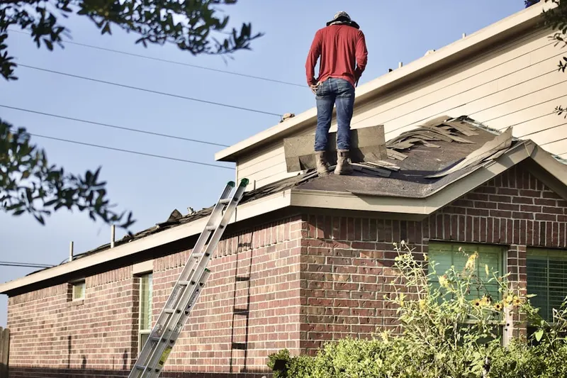 Professional roofer working on a residential roof in Parlier